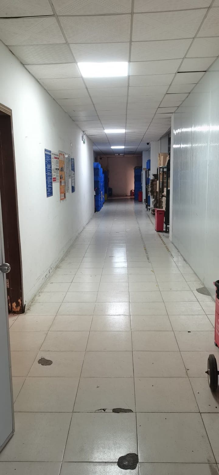 Factory internal corridor connecting production floor to storage and packing areas