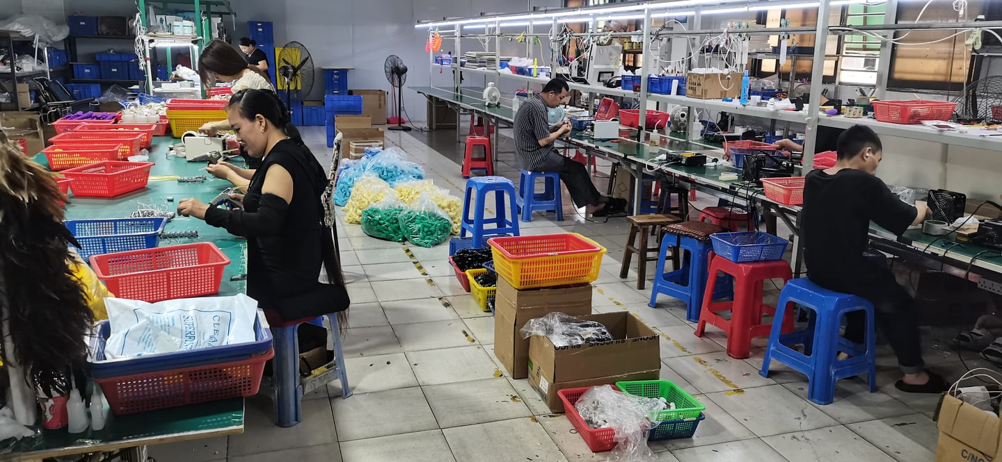 Workers at testing and assembly stations inspecting products during production at VOVOHO Dongguan facility