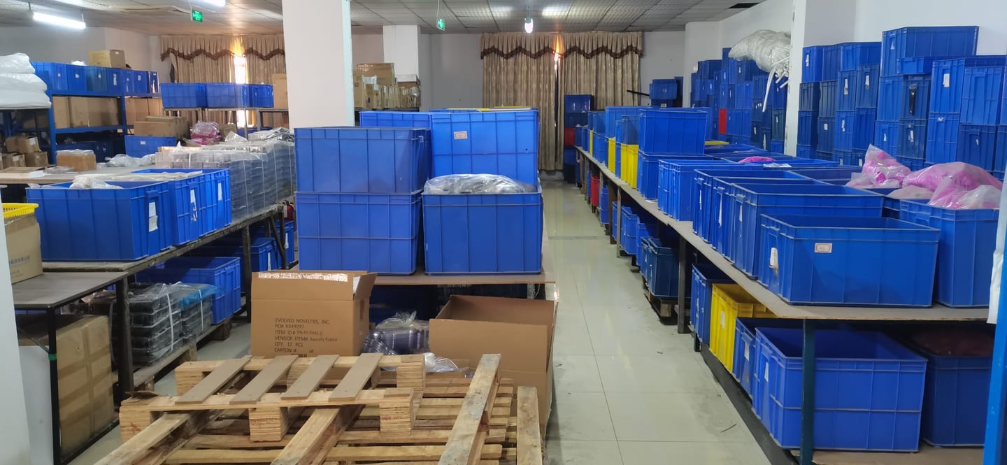 Finished-goods warehouse with organised blue bin inventory and export-ready shipping pallets